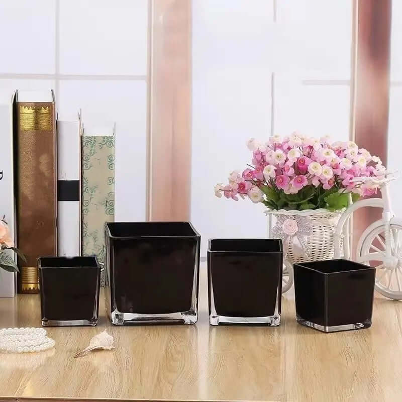 Black Square Glass Vase set on a table with floral arrangements