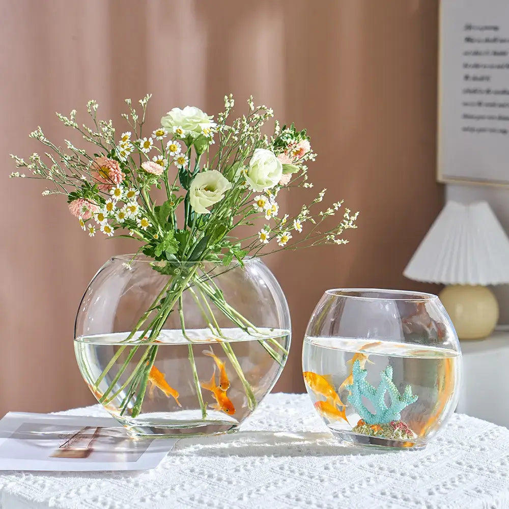 Clear oval glass vases showcasing flowers and goldfish