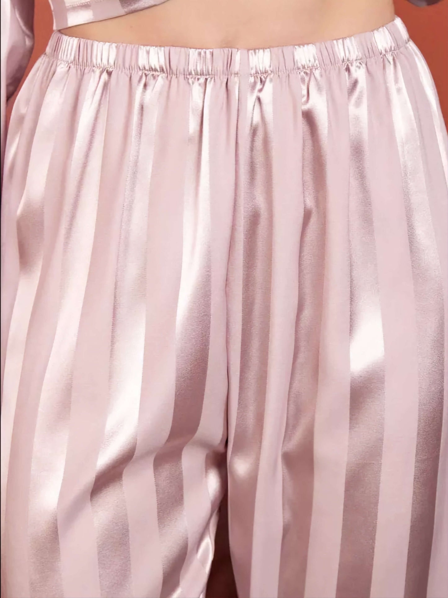 Close-up of pajama set trousers showcasing smooth texture and elegant stripes.